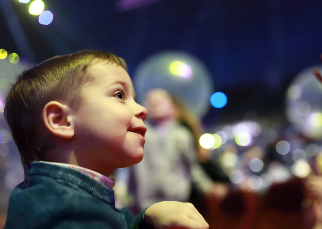 Young boy looks in wonder while attending a fun event.
